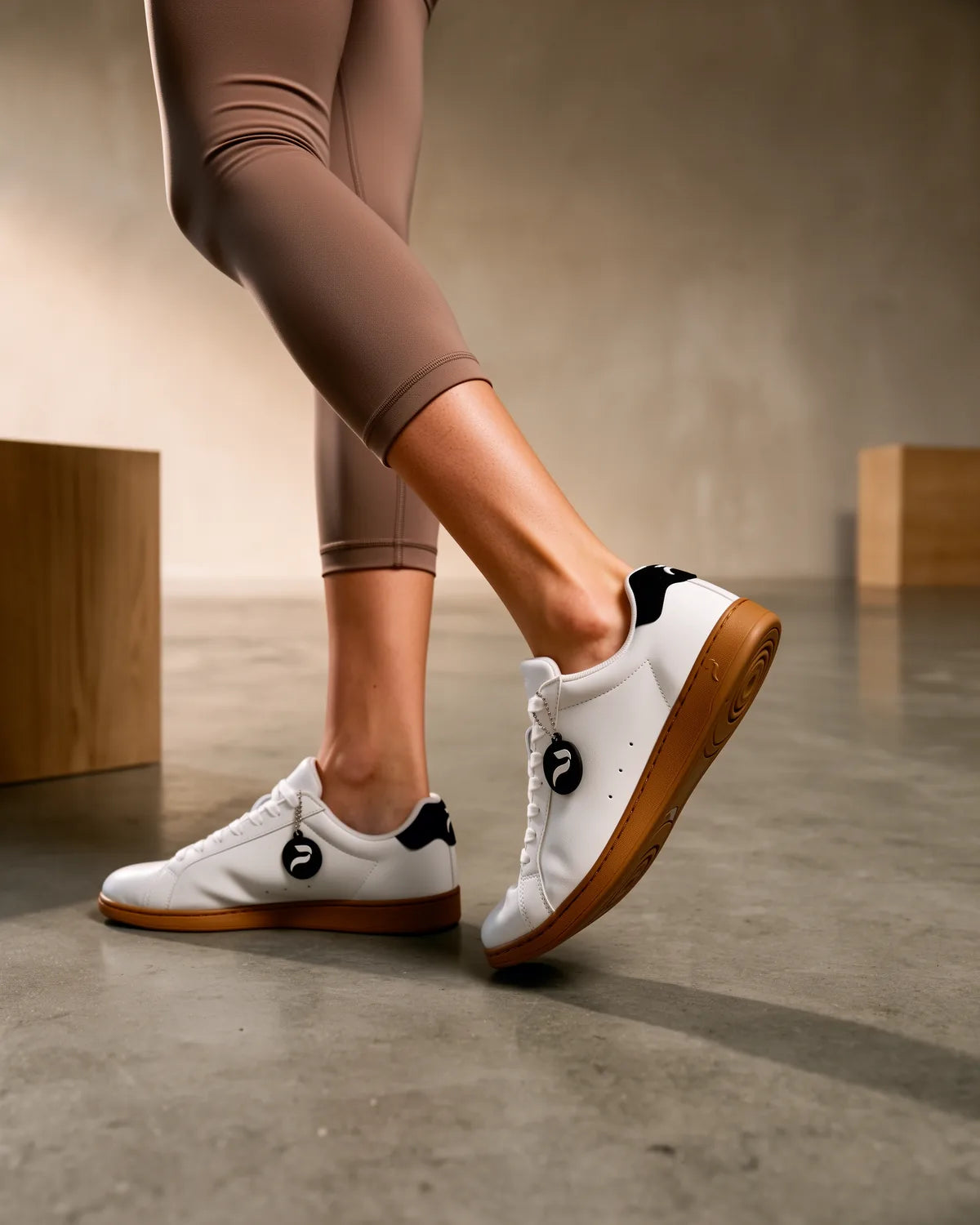 A dancer in Nova Court dance sneakers on a concrete floor.
